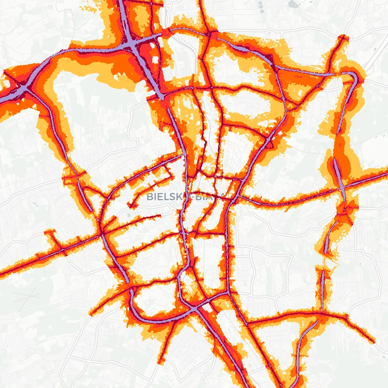 Noise map of Bielsko-Biała, Poland: road-traffic noise contours from the EU strategic noise maps, shaded yellow (≈55 dB Lden) through orange and red to dark purple (≈75 dB+), over the city's street network.