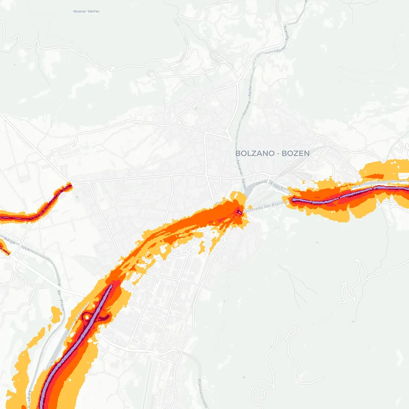 Noise map of Bolzano, Italy: road-traffic noise contours from the EU strategic noise maps, shaded yellow (≈55 dB Lden) through orange and red to dark purple (≈75 dB+), over the city's street network.