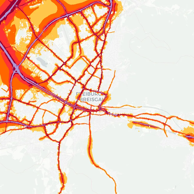 Noise map of Freiburg, Germany: road-traffic noise contours from the EU strategic noise maps, shaded yellow (≈55 dB Lden) through orange and red to dark purple (≈75 dB+), over the city's street network.