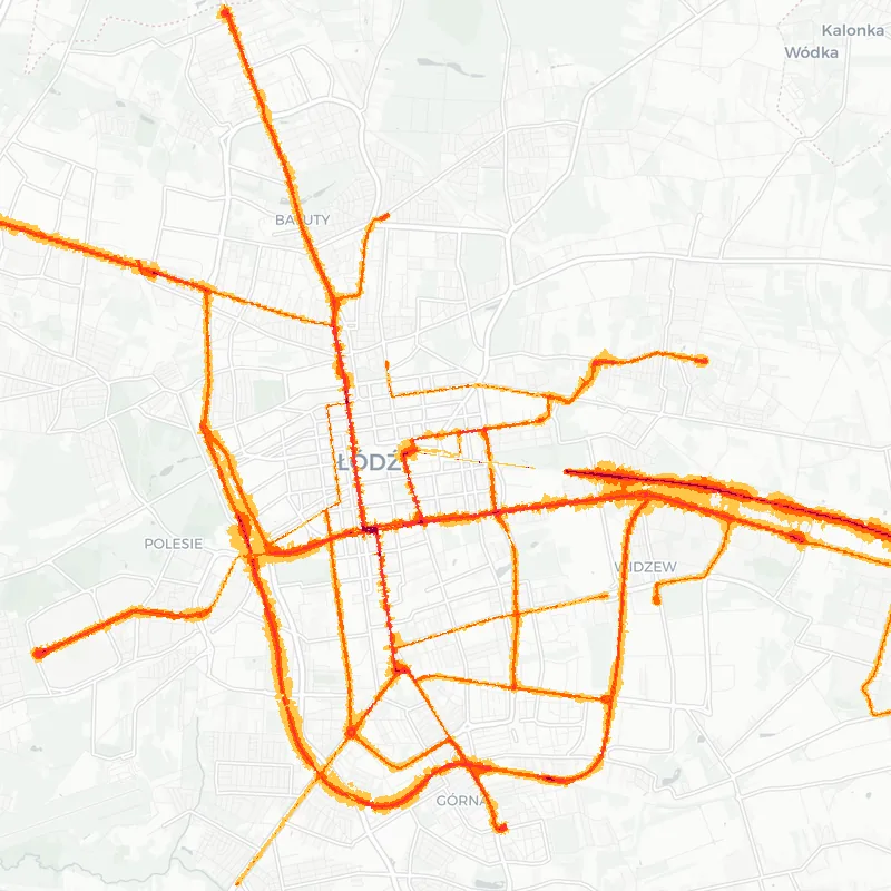 Noise map of Lodz, Poland: railway noise contours from the EU strategic noise maps, shaded yellow (≈55 dB Lden) through orange and red to dark purple (≈75 dB+), over the city's street network.