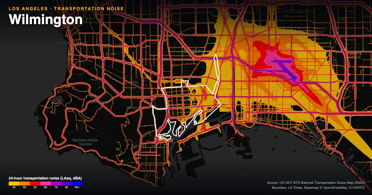 Transportation-noise map of Wilmington, Los Angeles: the neighborhood outlined in white over modeled road, rail and aircraft noise, colored from amber (about 45 dBA) through red and purple to blue (90 dBA and up).